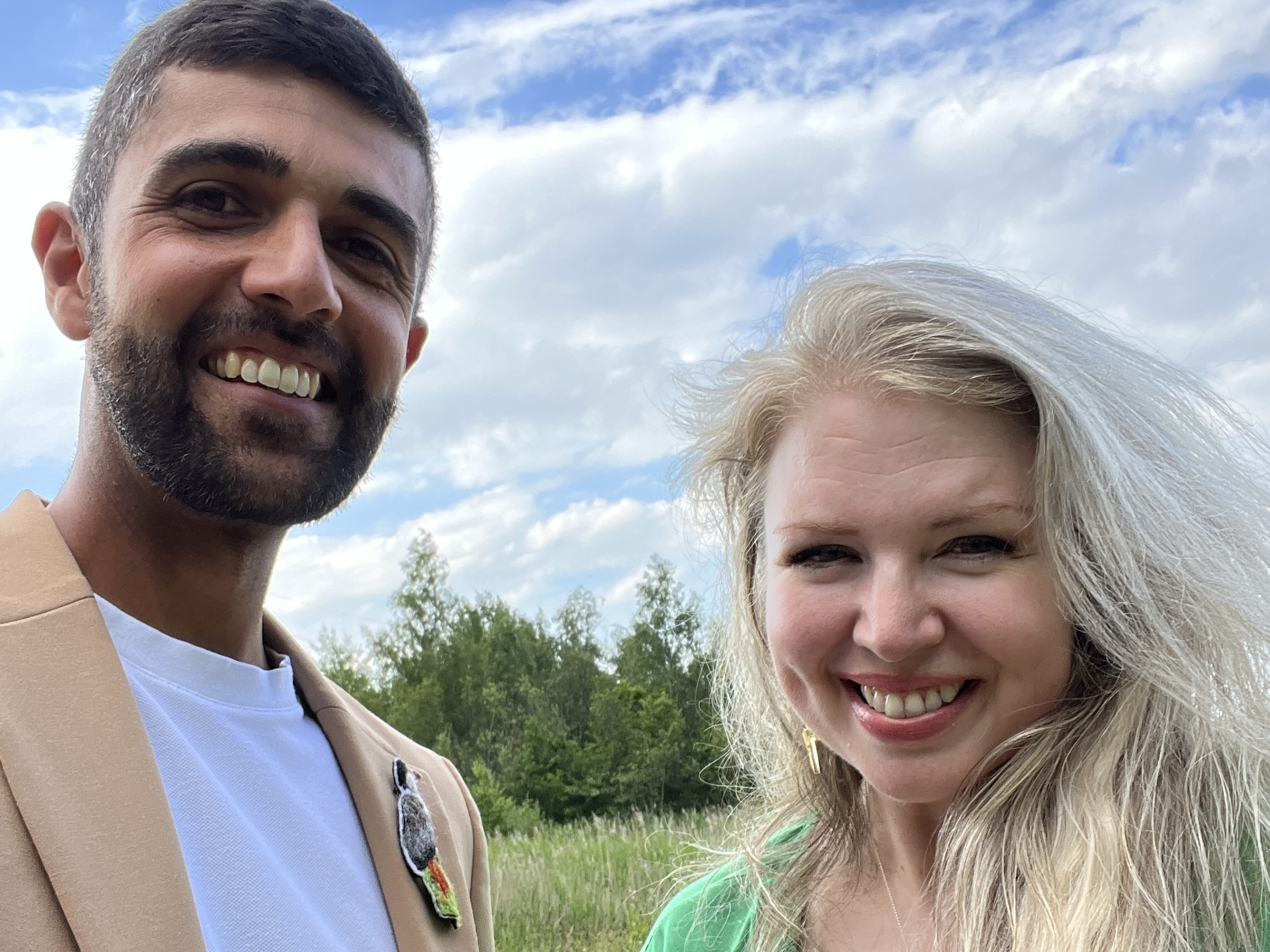 Ajay Tegala and Zoë Howe at RSPB Old Moor A selfie of two smiling faces with a blue sky and green trees behind them