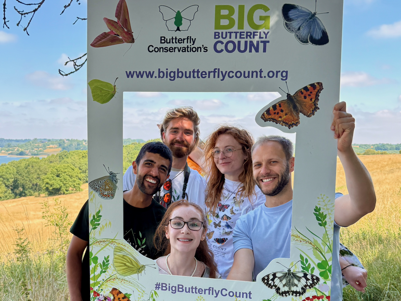 Ajay Tegala and the Butterfly Conservation ambassadors Five smiling young people holding up a sign promoting the Big Butterfly Count